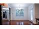 Bright dining area featuring hardwood floors, a modern chandelier, and a view of the backyard at 5808 Mcdowell Run Dr, Huntersville, NC 28078