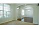 A neutral dining area with hardwood floors connects to the foyer with a large arched doorway at 5808 Mcdowell Run Dr, Huntersville, NC 28078
