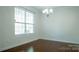 Well-lit dining room with hardwood floors and large window at 5808 Mcdowell Run Dr, Huntersville, NC 28078