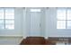 A bright foyer with hardwood floors, white walls and trim with two bright windows at 5808 Mcdowell Run Dr, Huntersville, NC 28078