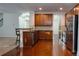 Spacious kitchen with wooden cabinets, stainless steel appliances, and hardwood flooring at 5808 Mcdowell Run Dr, Huntersville, NC 28078