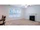 Inviting living room with a fireplace, a large window, and neutral carpeting at 5808 Mcdowell Run Dr, Huntersville, NC 28078