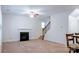 Comfortable living room with a fireplace, ceiling fan, and staircase access at 5808 Mcdowell Run Dr, Huntersville, NC 28078