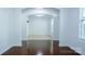 A neutral living space with hardwood floors, white walls and trim and multiple arched doorways at 5808 Mcdowell Run Dr, Huntersville, NC 28078