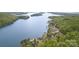 Breathtaking aerial view showcases a lakefront community surrounded by verdant woods and pristine waters at 602 Shoreline Rd # 144, New London, NC 28127