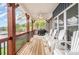 Back porch with wooden floors, a ceiling fan, outdoor seating and a grill with a view of the lake at 602 Shoreline Rd # 144, New London, NC 28127