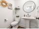 Well-lit powder room with a pedestal sink and decorative accents at 602 Shoreline Rd # 144, New London, NC 28127