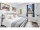 Comfortable bedroom featuring a metal frame bed, stylish decor, and a bright window at 602 Shoreline Rd # 144, New London, NC 28127