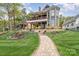 Beautiful two-story home with mature landscaping and a stone pathway at 602 Shoreline Rd # 144, New London, NC 28127