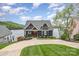 Inviting exterior showcases a well-manicured lawn, charming details, and a beautiful lake backdrop at 602 Shoreline Rd # 144, New London, NC 28127