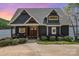 Charming exterior view showcasing craftsman details, beautiful landscaping, and a warm inviting entrance at 602 Shoreline Rd # 144, New London, NC 28127