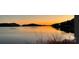 Beautiful sunset view over the lake with golden reflections, offering a serene and peaceful ambiance at 602 Shoreline Rd # 144, New London, NC 28127