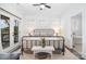 Inviting primary bedroom with a wrought iron bed frame and french doors at 602 Shoreline Rd # 144, New London, NC 28127