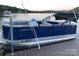Lexington Pontoon Boat with blue hull docked on the lake featuring comfortable gray upholstery at 602 Shoreline Rd # 144, New London, NC 28127