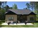 Staged backyard patio with dining and seating, overlooking a home with neutral siding at 6519 Pargo Rd, Charlotte, NC 28216
