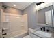 Bathroom with a shower-tub combo and a vanity with a framed mirror, and granite countertop at 6519 Pargo Rd, Charlotte, NC 28216