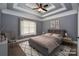 Virtually staged bedroom features a cozy bed, soft lighting and stylish decor at 6519 Pargo Rd, Charlotte, NC 28216