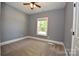 Comfortable bedroom with neutral carpet, a ceiling fan, natural light from the window, and painted in a neutral color at 6519 Pargo Rd, Charlotte, NC 28216