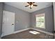 Cozy bedroom with neutral carpet, a ceiling fan, natural light from the window, and painted in a neutral color at 6519 Pargo Rd, Charlotte, NC 28216