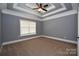 Spacious bedroom with large window and tray ceiling at 6519 Pargo Rd, Charlotte, NC 28216