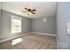 Comfortable bedroom with neutral carpet, a ceiling fan, natural light from the window, and painted in a neutral color at 6519 Pargo Rd, Charlotte, NC 28216