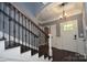Welcoming home foyer showcasing dark wood floors, iron railing, and a front door allowing natural light at 6519 Pargo Rd, Charlotte, NC 28216
