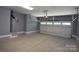 Spacious garage with a concrete floor, and an automatic door with upper windows at 6519 Pargo Rd, Charlotte, NC 28216