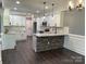 Spacious kitchen with white cabinets, a stone island, granite countertops, and stainless steel appliances at 6519 Pargo Rd, Charlotte, NC 28216