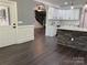 Open kitchen featuring an island with a stone base, granite countertops, and white cabinets at 6519 Pargo Rd, Charlotte, NC 28216