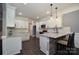 Modern kitchen with white cabinets, granite countertops, and a breakfast bar with chairs at 6519 Pargo Rd, Charlotte, NC 28216