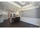Bright kitchen featuring white cabinets, granite countertops, stainless appliances, and dark wood floors at 6519 Pargo Rd, Charlotte, NC 28216