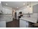 Bright kitchen with white cabinets, stainless appliances, granite countertops, and sleek dark-wood flooring at 6519 Pargo Rd, Charlotte, NC 28216