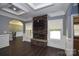 Open concept living room features a stone fireplace, dark wood floors, and abundant natural light at 6519 Pargo Rd, Charlotte, NC 28216