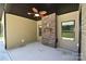 Covered porch with a ceiling fan and a brick accent wall, creating an inviting outdoor space at 6519 Pargo Rd, Charlotte, NC 28216