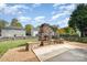 Spacious backyard featuring a stone fireplace and patio perfect for outdoor gatherings at 6618 Latherton Ln, Charlotte, NC 28278