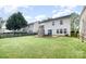 Backyard view highlighting the stone fireplace feature and ample green space at 6618 Latherton Ln, Charlotte, NC 28278