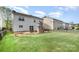Lush backyard showcasing a stone fireplace and a spacious grassy area at 6618 Latherton Ln, Charlotte, NC 28278