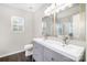 Stylish bathroom features a double sink vanity, elegant mirrors, and a window for natural light, creating a serene space at 6618 Latherton Ln, Charlotte, NC 28278