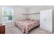 Inviting bedroom featuring natural light, a wardrobe closet, and simple decor, perfect for creating a cozy and restful space at 6618 Latherton Ln, Charlotte, NC 28278
