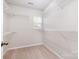 Walk-in closet featuring ample shelving, and a window for natural light, providing plenty of storage and organization at 6618 Latherton Ln, Charlotte, NC 28278