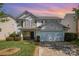 Charming two-story home with a well-manicured lawn and attached two-car garage with neutral siding at 6618 Latherton Ln, Charlotte, NC 28278