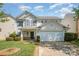 Charming two-story home with a well-manicured lawn and attached two-car garage with neutral siding at 6618 Latherton Ln, Charlotte, NC 28278