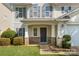 Inviting front porch of a two-story home with brick accents, white columns, and a well-maintained lawn at 6618 Latherton Ln, Charlotte, NC 28278