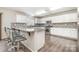 Bright eat-in kitchen with white cabinets, granite counters and stainless steel appliances at 6618 Latherton Ln, Charlotte, NC 28278