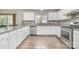 Well-lit eat-in kitchen featuring stainless steel appliances, modern countertops and ample storage at 6618 Latherton Ln, Charlotte, NC 28278