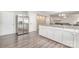 Modern kitchen boasts stainless steel refrigerator and granite countertop island at 6618 Latherton Ln, Charlotte, NC 28278