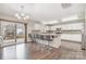 Eat-in kitchen with an island featuring bar seating, wood floors, and stainless steel appliances at 6618 Latherton Ln, Charlotte, NC 28278