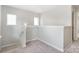 Bright and airy landing area with natural light and neutral carpet at 6618 Latherton Ln, Charlotte, NC 28278