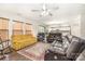 Bright living room with wood floors, ceiling fan, and open view to the kitchen at 6618 Latherton Ln, Charlotte, NC 28278