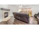 Cozy living room with a stone fireplace, hardwood floors, and comfortable seating by bright windows at 6618 Latherton Ln, Charlotte, NC 28278